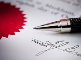 Close-up of a notarized document with a principal's signature and a red wax seal, symbolizing legal certification.